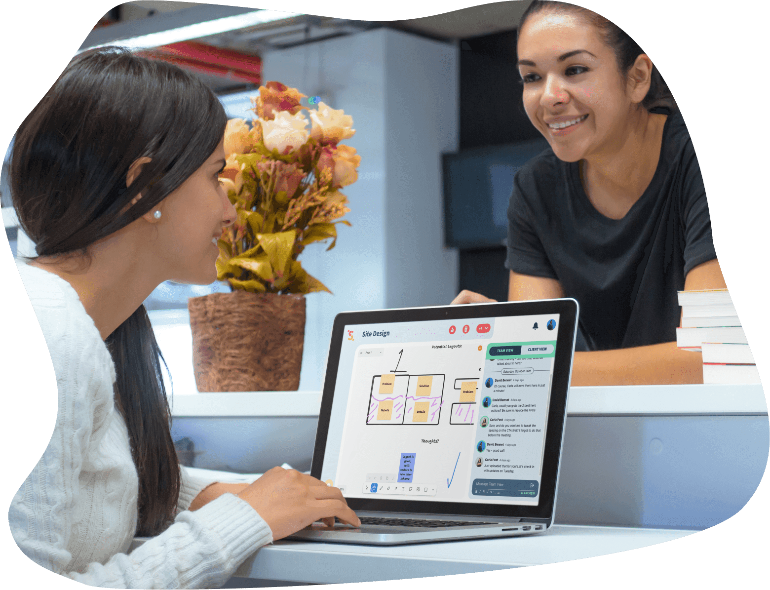 2 women talking over a laptop where one is using Sketchback